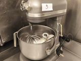 a mixer in the kitchen with a bowl on the counter