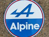 an alpine sticker on the ground of a parking lot