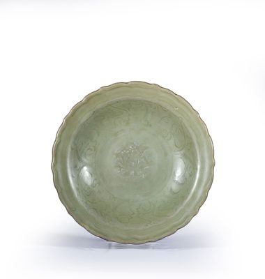 a green bowl sitting on top of a white table
