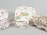 three pieces of porcelain on display on a table