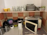 a microwave that is sitting on a shelf in a kitchen