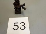 a close up of a small figurine on a table next to a number