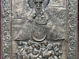 a close up of a metal plaque with a picture of jesus on it
