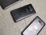 three cell phones are sitting next to each other on the floor