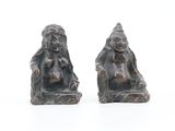 pair of bronze figurines of a man and a woman sitting on a bench