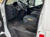 a white van with the door open on the side of the road