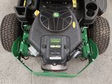 a picture of a lawn mower sitting on the ground