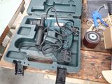 a tool box with a drill and other tools on a table