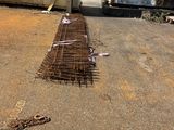 a pile of sticks laying on the ground next to a trailer
