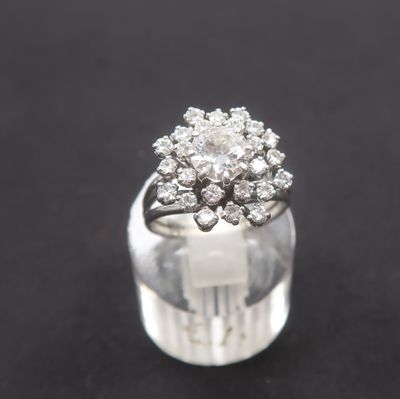 a close up of a diamond ring on a black surface