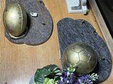 a vase of flowers and a soccer ball on a table