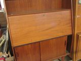 a wooden cabinet with a mirror on top of it