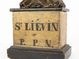 an antique bronze statue of a woman sitting on top of a box