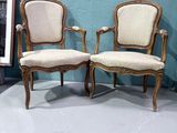 two chairs sitting next to each other in a room