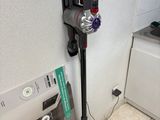 a vacuum that is sitting on the floor in the kitchen