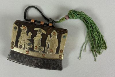 a picture of a gold and black purse with a green tassel