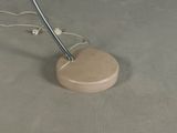 a wooden stand with a metal object on top of it