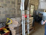 a man that is standing in a room with a ladder