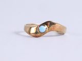 an image of a gold ring with a blue stone in the middle