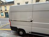 a white van that is parked on the side of the street