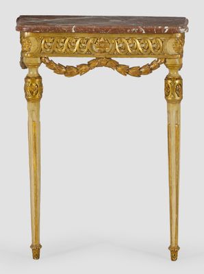 a gold console table with a marble top