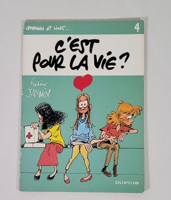 un livre sur lequel figure une illustration représentant trois filles assises sur un banc