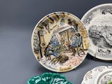 three plates with different designs and designs on them sitting on a table