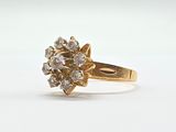 an image of a gold ring with a cluster of diamonds on it