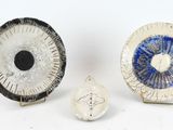 three pieces of art that are sitting on top of a table
