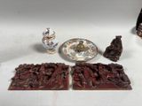 a table with a plate, a bowl, and a plate with figurines on it