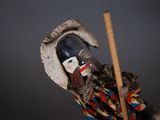 a toy soldier with a wooden stick in his hand