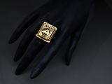 a close up of a person ' s hand with a gold ring on it