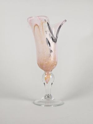 a glass vase with a pink liquid inside of it