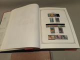 an open book with stamps on it sitting on a table