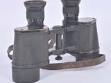 an old pair of binoculars sitting on top of a white surface
