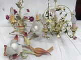 a lot of flowers and a chandelier on a table