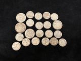 a pile of silver coins sitting on top of a black surface