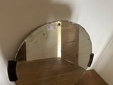a mirror that is sitting on a table in a room