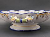 a white bowl with blue and yellow designs on it