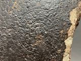 a close up of a metal object on a gray surface