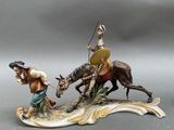 figurine of a man on a horse and a man on a horse with a spear