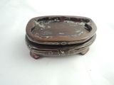 a small wooden box with a decorative design on it