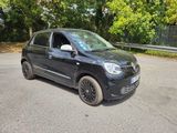 a picture of a small black car parked on the side of the road