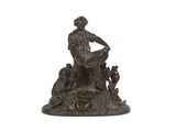 statue représentant un homme assis sur un rocher, accompagné d'un chien et d'un chat