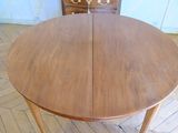 a wooden table with two leaves on top of it
