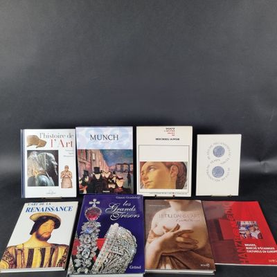 several books are arranged on a black surface with a black background