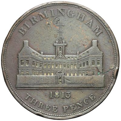 an old coin with a picture of a building on it