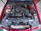 a red car with its hood open and the engine in it