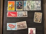 an open book with stamps on it sitting on a table