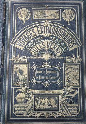 an old book sitting on top of a table covered in pictures